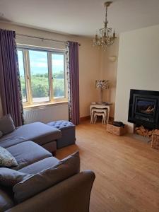a living room with a couch and a fireplace at Sioscadh na Mara in Spiddal