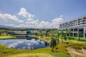 an office building with a river in front of a building at ILLITE Hotel in Yŏngdong