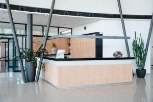 an office lobby with a reception desk and potted plants at Hotel Hegau in Engen
