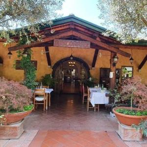 a restaurant with tables and chairs in a building at Guest house Romana Vecchia in Monticchio
