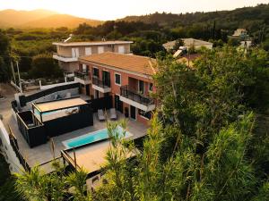 an aerial view of a house with a swimming pool at Corfu Mylos in Ágios Nikólaos