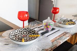 a table with three bowls and wine glasses on it at Cloud Nine, 5mins ORLY Airport Apt 22 in Athis-Mons
