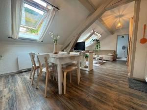 a dining room and living room with a table and chairs at L'Escapade Montagneuse in Eaux-Bonnes +30 photos