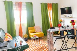a living room with green curtains and a table at Cloud Nine, 5mins ORLY Airport Apt 22 in Athis-Mons