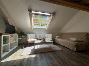a living room with a couch and a table at L'Escapade Montagneuse in Eaux-Bonnes