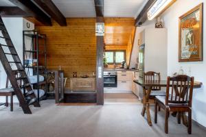 a kitchen with a staircase and a table and chairs at Apartment am Bullerbach Deister in Barsinghausen +41 photos