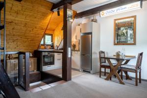 a kitchen with a table and a refrigerator at Apartment am Bullerbach Deister in Barsinghausen