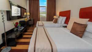 Postel nebo postele na pokoji v ubytování Mangrove Hotel