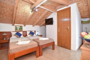 a bedroom with a bed and a television in a room at Villa Pedja Zec in Budva