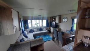 a living room with a couch and a table at Rose bank Retreat in Hunmanby