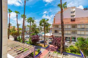 a view of a city street with palm trees and a building at Modern brand new Apartment Torrevieja Centre 2 in Torrevieja