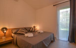 a bedroom with a bed with two towels on it at Bilocale in Costa Rei