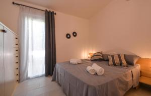 a bedroom with a bed with two towels on it at Bilocale in Costa Rei