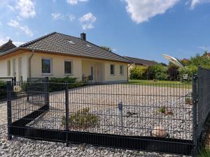 a fence in front of a house at Am Krabbenweg Whg.1 im Haus Am Krabbenweg in Insel Poel