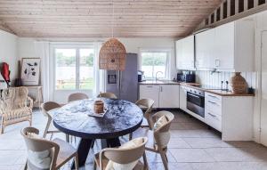 a kitchen with a table and chairs in a room at 2 Bedroom Lovely Home In Haugesund in Haugesund +13 photos