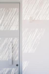 a white door with a pattern of lines on it at Quartano Suites by Heliessa, Adults Only in Naousa