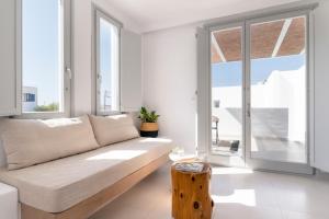 a living room with a couch and a table at Quartano Suites by Heliessa, Adults Only in Naousa