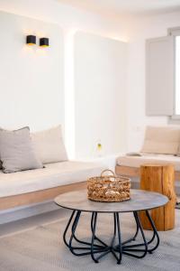 a living room with a couch and a table at Quartano Suites by Heliessa, Adults Only in Naousa