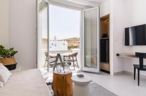 a living room with a couch and a table at Quartano Suites by Heliessa, Adults Only in Naousa