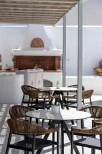 a group of tables and chairs in a restaurant at Quartano Suites by Heliessa, Adults Only in Naousa
