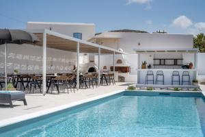 a villa with a swimming pool and a patio at Quartano Suites by Heliessa, Adults Only in Naousa