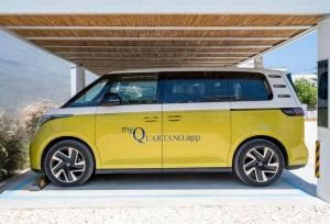a yellow and white van parked under a building at Quartano Suites by Heliessa, Adults Only in Naousa