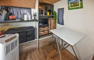 a small kitchen with a table and a stove at Gorgeous Stacaravan in Pernes-les-Fontaines