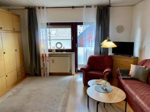 a living room with a couch and a table at Ferienwohnung "Strandoase" in Burhave