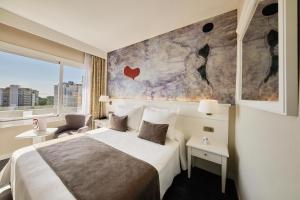 a hotel room with a bed and a large window at Hotel Joan Miró Museum in Palma de Mallorca