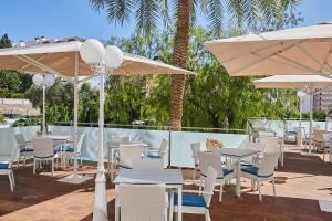 a patio with tables and chairs and umbrellas at Hotel Joan Miró Museum in Palma de Mallorca +37 photos
