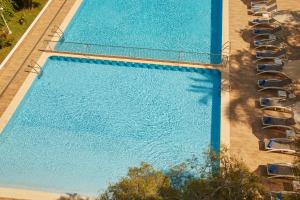 an overhead view of a large swimming pool with chairs at Hotel Joan Miró Museum in Palma de Mallorca