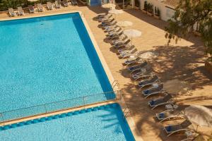 an overhead view of a pool with chairs and umbrellas at Hotel Joan Miró Museum in Palma de Mallorca