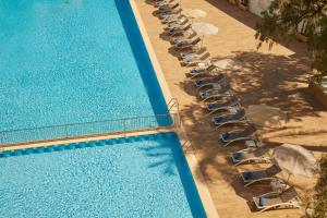 an overhead view of a pool with chairs and umbrellas at Hotel Joan Miró Museum in Palma de Mallorca