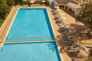 an overhead view of a large swimming pool with chairs at Hotel Joan Miró Museum in Palma de Mallorca