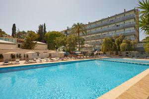 a large swimming pool in front of a hotel at Hotel Joan Miró Museum in Palma de Mallorca