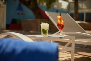 two cocktails sitting on a table on a chair at Hotel Joan Miró Museum in Palma de Mallorca