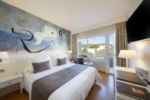 a bedroom with a large bed and a large window at Hotel Joan Miró Museum in Palma de Mallorca