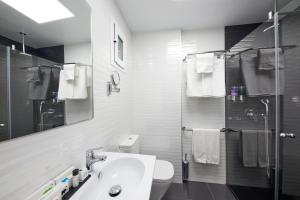 a bathroom with a sink and a toilet and a shower at Hotel Joan Miró Museum in Palma de Mallorca