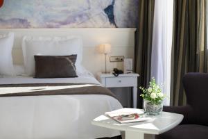 a bedroom with a bed and a table with a chair at Hotel Joan Miró Museum in Palma de Mallorca