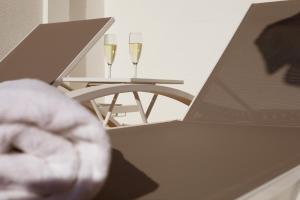 two glasses of champagne on a table with a laptop at Hotel Joan Miró Museum in Palma de Mallorca
