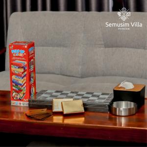 a chess board on top of a table with a couch at Sierra by Semusim Villa in Cianjur +23 photos