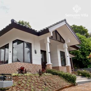 a house with a white at Sierra by Semusim Villa in Cianjur