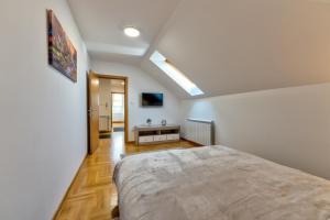 a bedroom with a large bed in a room at CENTRUM APARTMENT Zlatibor in Zlatibor