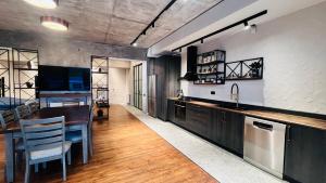 a kitchen with a table and a counter top at Pool House in Yerevan