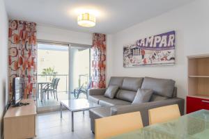 a living room with a couch and a table at Apartamentos Hipocampos Calpe Rent Apart in Calpe