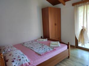a bedroom with a bed and a cabinet in it at Hotel Toni Llogora in Llogara