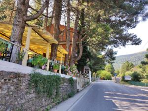 a street with a building on the side of a road at Hotel Toni Llogora in Llogara +21 photos