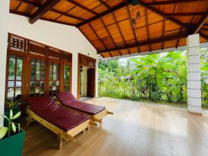 an outdoor patio with benches and a large window at Ceylon Serenity Villas in Beruwala