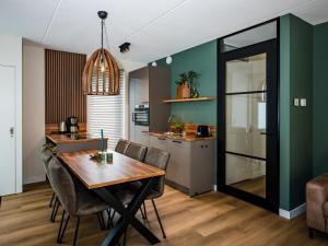 a kitchen and dining room with a table and chairs at Holiday Home in Voorthuizen near Veluwe in Voorthuizen