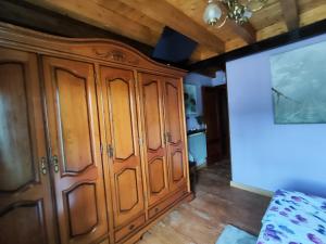 a large wooden cabinet in a room with wooden floors at Pensión Los Pasiegos in Reocín +18 photos